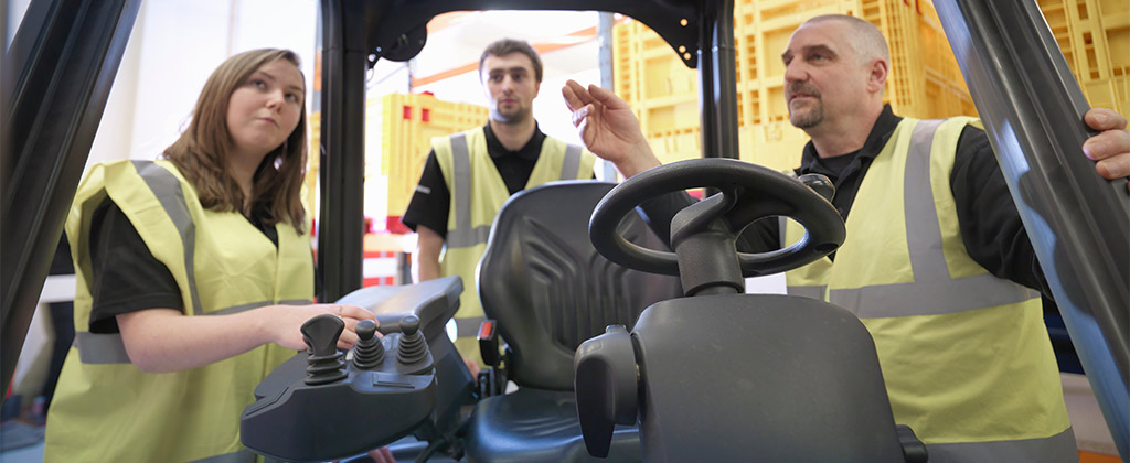 Forklift expert teaching others the equipment terms of the machine